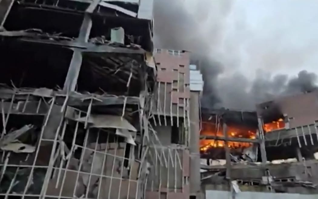 This video grab taken from undated UGC images posted on social media on March 23, 2026, shows destruction and fire at the Iranian ministry of defence's electronics industries building in Tehran following a strike. Iranian media said on March 23 there were no negotiations between Tehran and Washington after the US president announced talks towards ending the war. (Photo by various sources / AFP) /