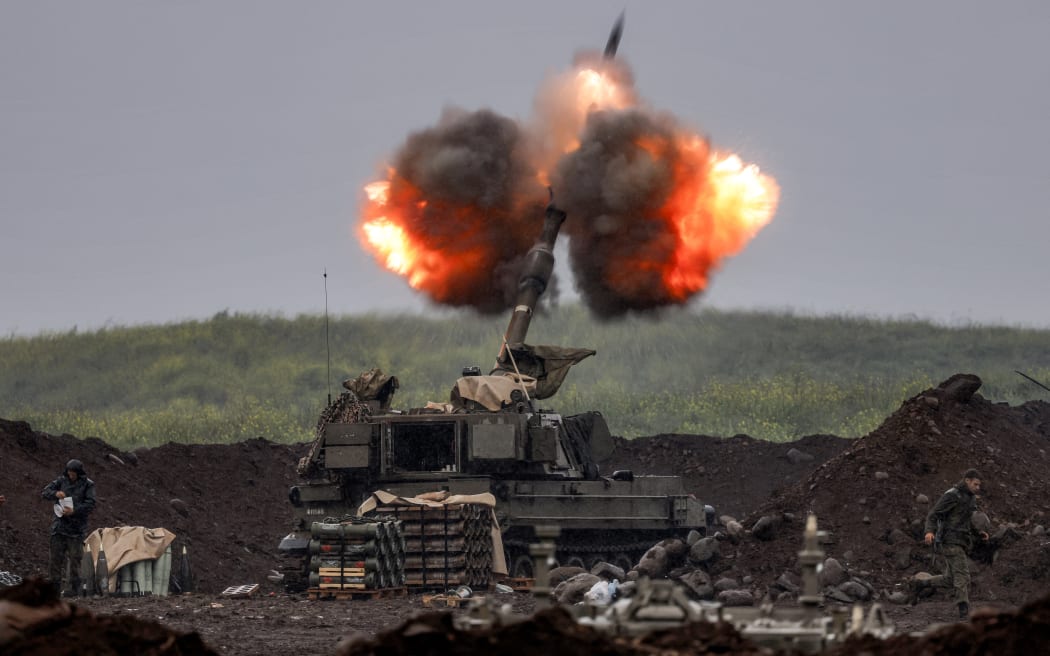 An Israeli self-propelled howitzer artillery gun fires rounds towards southern Lebanon from a position in the upper Galilee in northern Israel near the border on March 20, 2026. Lebanon was drawn into the Middle East war on March 2 when Iran-backed Hezbollah militants launched rockets at Israel after the killing of the Islamic republic's supreme leader. (Photo by Jalaa MAREY / AFP) /
