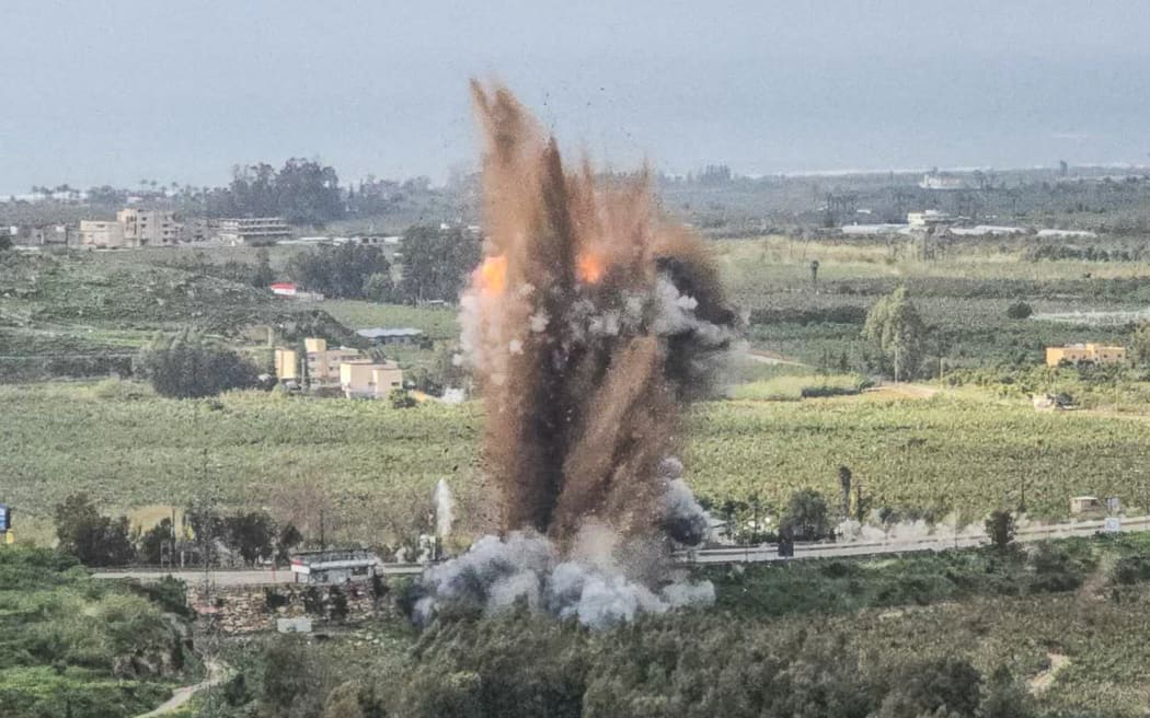 A fireball rises from the site of an Israeli airstrike that targeted the Qasmiyeh bridge, located on a main highway linking villages in the Tyre district with others further north, after Israel said the bridge was being used by Hezbollah, in southern Lebanon on March 22, 2026. Israel's military struck a key bridge in south Lebanon on March 22, an AFP correspondent said, after Israel's defence minister said the army had been ordered to destroy more bridges over the Litani River. Lebanon was drawn into the Middle East war on March 2, when pro-Iran Hezbollah launched rockets towards Israel in response to US-Israeli strikes that killed Iranian supreme leader on February 28, 2026. (Photo by Kawnat HAJU / AFP) /