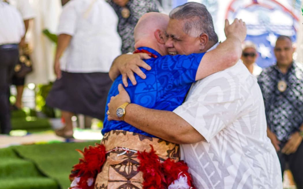 New Zealand PM Christopher Luxon embraces his Samoan counterpart La'aulialemalietoa Leuatea Schmidt during the matai title ceremony in Apia on Monday. 16 March 2026