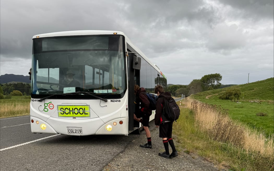 Students get on school bus they won't be able to catch next term.