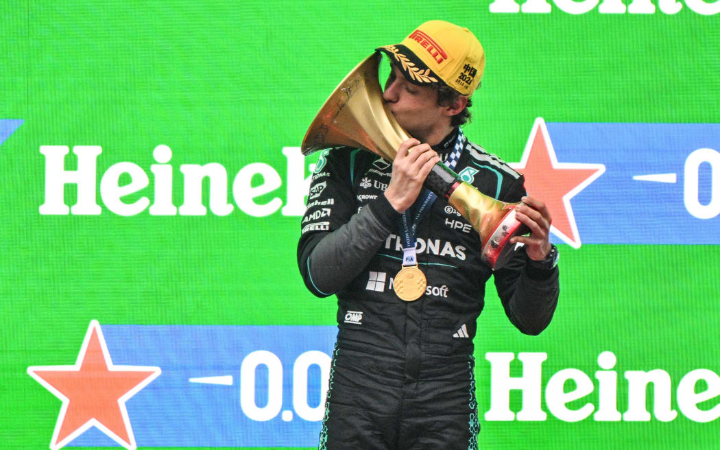 Winner Mercedes' Italian driver Kimi Antonelli celebrates on the podium after the Formula One Chinese Grand Prix, 2026.
