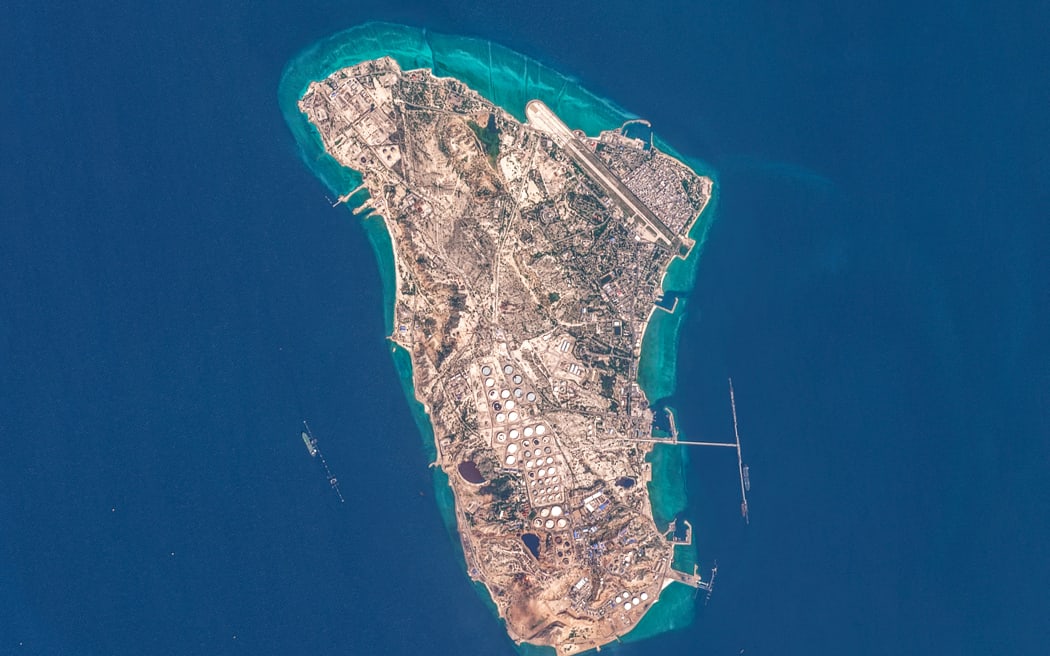 This handout image taken by the European Space Agency (ESA) captured by the Copernicus Sentinel-2 satellite shows a view of Iran's Kharg Island, which hosts the country’s main crude export terminal and is responsible for the overwhelming majority of its oil shipments to the world, about 30 kilometres south of the mainland in the north of the Gulf, on March 7, 2026. The US and Israel have previously treaded carefully around the island in the conflict, but an Axios report over the weekend cited Trump administration officials saying capturing Kharg was on the table. The island handles roughly 90 percent of Iran's crude exports, according to a JP Morgan note released on March 8. (Photo by EUROPEAN SPACE AGENCY / AFP) / RESTRICTED TO EDITORIAL USE - MANDATORY CREDIT "AFP PHOTO / ESA" - HANDOUT - NO MARKETING NO ADVERTISING CAMPAIGNS - DISTRIBUTED AS A SERVICE TO CLIENTS