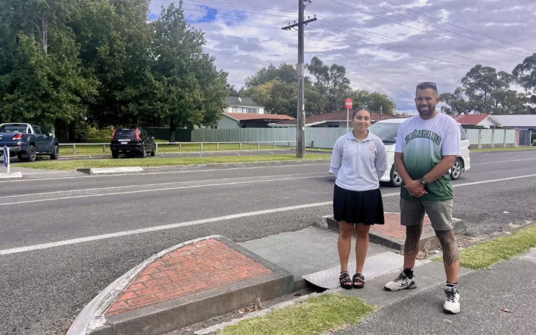 Te Kura Kaupapa Māori o Ngā Uri a Māui student Malea, 15, and father Raniera Procter pictured beside a raised entry and exit foundation, where they want a pedestrian crossing installed. Photo / Zita Campbell