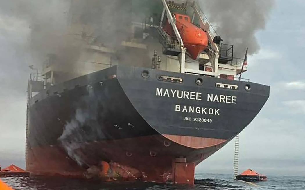 This handout photo taken on March 11, 2026 and released by the Royal Thai Navy shows smoke rising from the Thai bulk carrier 'Mayuree Naree' near the Strait of Hormuz after an attack. A Thai bulk carrier travelling in the crucial Strait of Hormuz was attacked March 11, with 20 crew members rescued so far, the Thai navy said. (Photo by Handout / ROYAL THAI NAVY / AFP) / -----EDITORS NOTE --- RESTRICTED TO EDITORIAL USE - MANDATORY CREDIT "AFP PHOTO / ROYAL THAI NAVY " - NO MARKETING - NO ADVERTISING CAMPAIGNS - DISTRIBUTED AS A SERVICE TO CLIENTS -