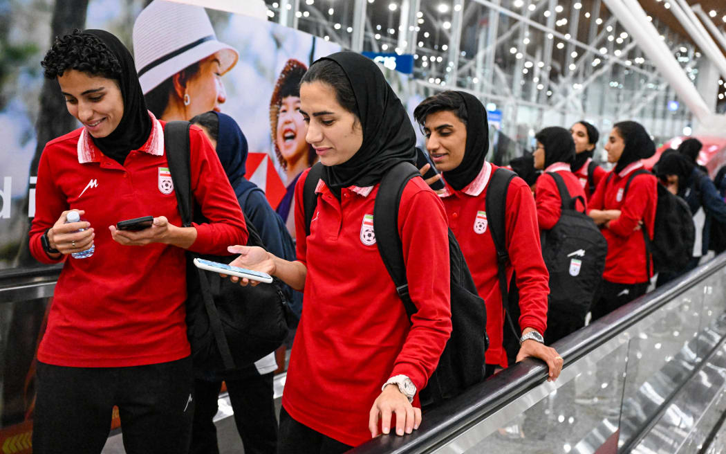 Members of Iran's women's football team arrive at the Kuala Lumpur International Airport after taking part in the AFC Women’s Asian Cup Australia 2026 tournament in Australia, in Sepang on March 11, 2026. At least five players from Iran's visiting women's football team claimed asylum in Australia on on March 10, seeking protection after they were branded "traitors" at home for refusing to sing the national anthem. (Photo by Mohd RASFAN / AFP)