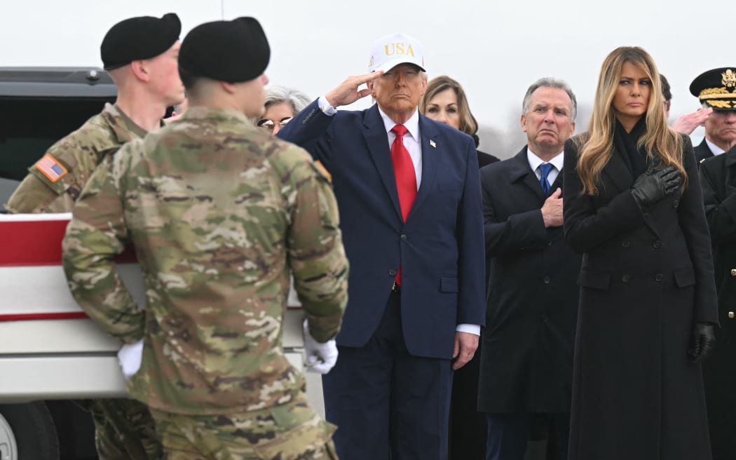 US President Donald Trump salutes as members of a US Army team carry the flagged-drapped transfer case containing the remains of US soldier Sgt. 1st Class Nicole M. Amor during a dignified transfer solemn event at Dover Air Force Base, in Dover, Delaware, on March 7, 2026. Six US Army soldiers were killed March 1 when an Iranian drone struck a key US command center in Kuwait's southern industrial hub of Port Shuaiba, a day after the United States and Israel launched a sweeping military campaign against Iran. (Photo by SAUL LOEB / AFP)