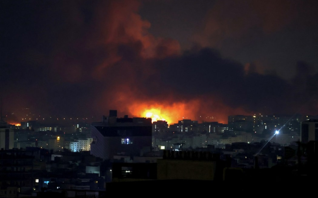 Smoke and fire rise from the site of airstrikes at Mehrabad International Airport in Tehran on 7 March, 2026.
