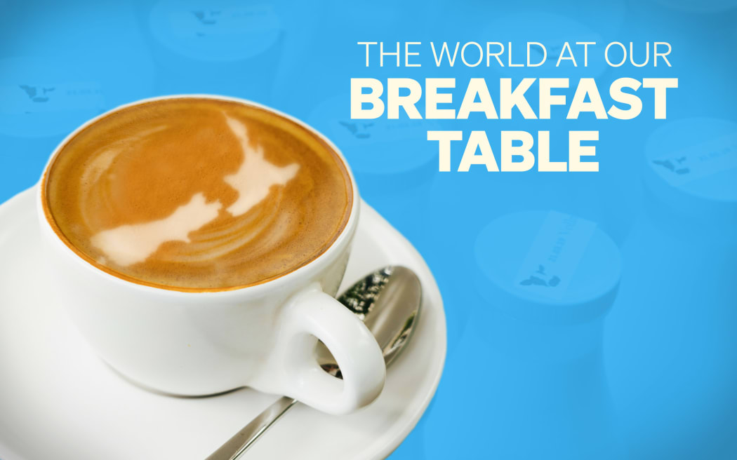 The world at our breakfast table: Flat white with shape of NZ in foam.