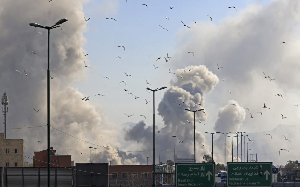 A plume of smoke rises after a strike on the Iranian capital of Tehran on March 5, 2026. Israel pounded Tehran with fresh strikes and Iran targeted Kurdish guerilla groups in Iraq on March 5 as a spiralling war in the Middle East engulfed the entire region. (Photo by Atta KENARE / AFP)
