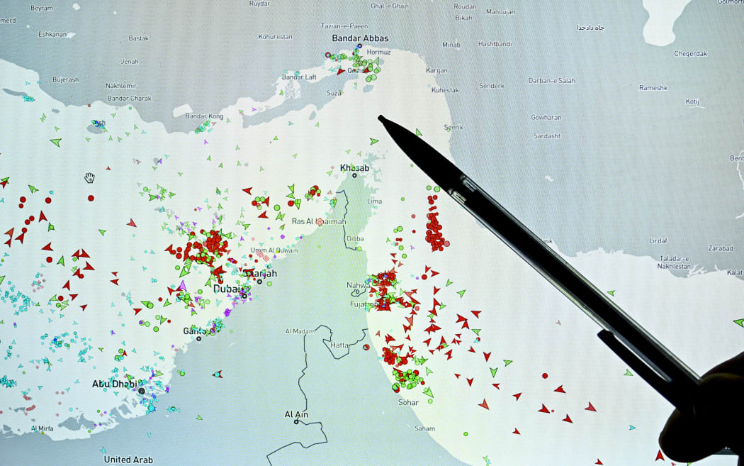 A person points at a page on the Marinetraffic website that shows commercial boats traffic on the edge of the Strait of Hormuz near the Iranian coast, in Paris on March 4, 2026. (Photo by JULIEN DE ROSA / AFP)