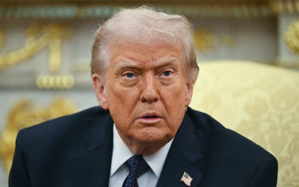US President Donald Trump looks on during a meeting with German Chancellor Friedrich Merz in the Oval Office of the White House in Washington, DC on March 3, 2026. Chancellor Merz is the first European leader to visit President Trump since the United States and Israel launched their war against Iran. (Photo by ANDREW CABALLERO-REYNOLDS / AFP)