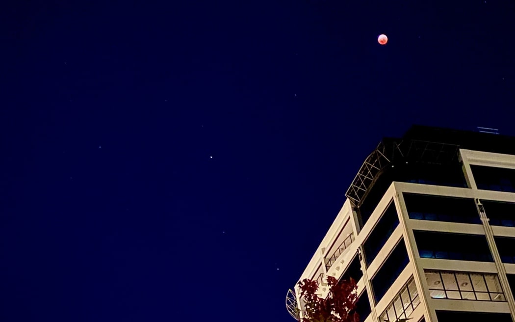 The moon above a building in Auckland.