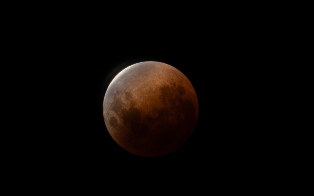 A small crescent of a the moon remains visible during the total lunar eclipse - taken at 12:04am on 4 March 2026 in Hobsonville, Auckland