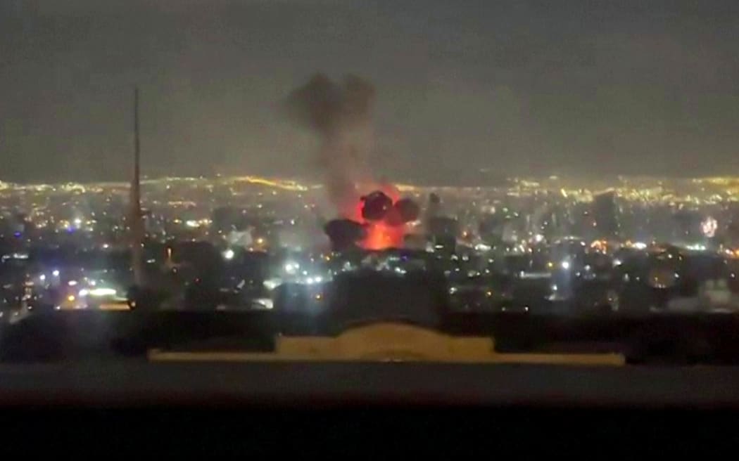 This video grab taken from UGC images posted on social media on March 1, 2026 shows an explosion following a strike on Tehran that appears to have occurred near state television channel IRIB. The United States and Israel launched strikes against Iran on February 28, with Israel's public broadcaster reporting that the Iranian supreme leader had been targeted, as the Islamic republic retaliated with barrages of missiles at Gulf states and Israel. (Photo by UGC / AFP) / NO USE AFTER MARCH 16, 2026 20:56:18 GMT - RESTRICTED TO EDITORIAL USE - MANDATORY CREDIT AFP - SOURCE: UGC / UNKNOWN - DISTRIBUTED AS A SERVICE TO CLIENTS - NO RESALE -