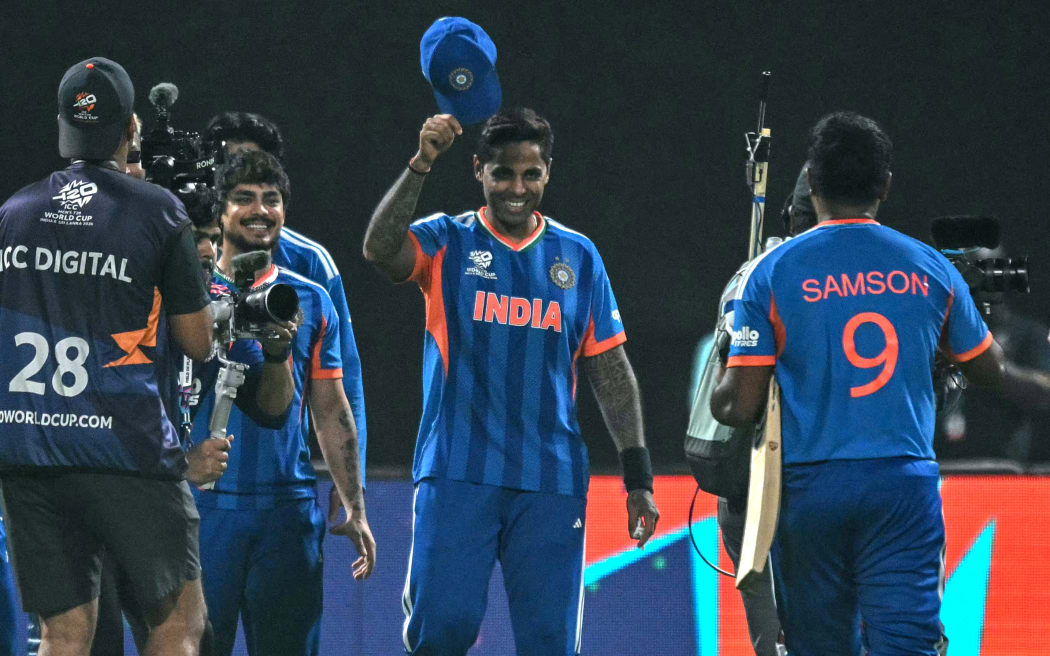 India's captain Suryakumar Yadav (C) greets his teammate Sanju Samson (R).