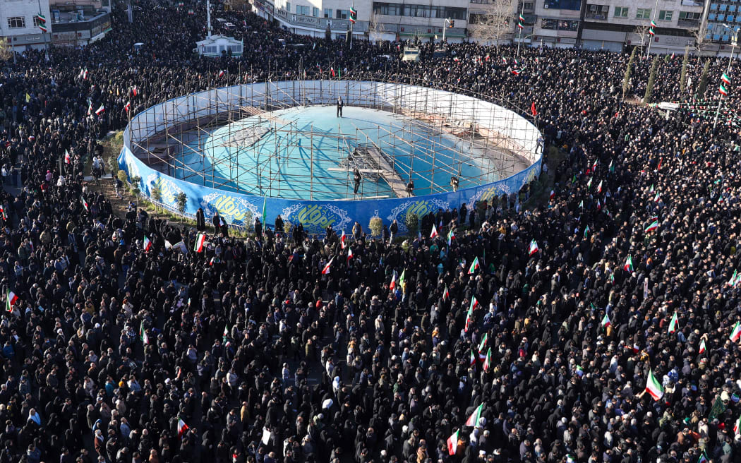 People gather to mourn the death of Iran’s supreme leader Ayatollah Ali Khamenei, who was killed in joint US and Israeli strikes, at a square in Tehran.
