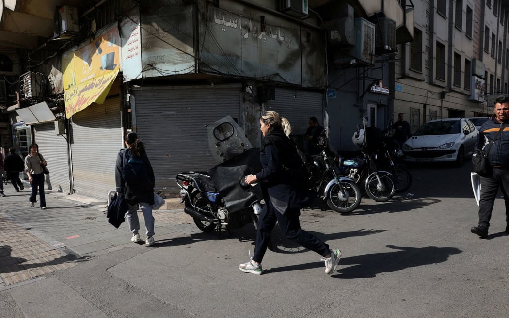 People run for cover following an explosion in Tehran, on Saturday, February 28.
Mandatory Credit: Majid Asgaripour/West Asia News Agency/Reuters via CNN Newsource