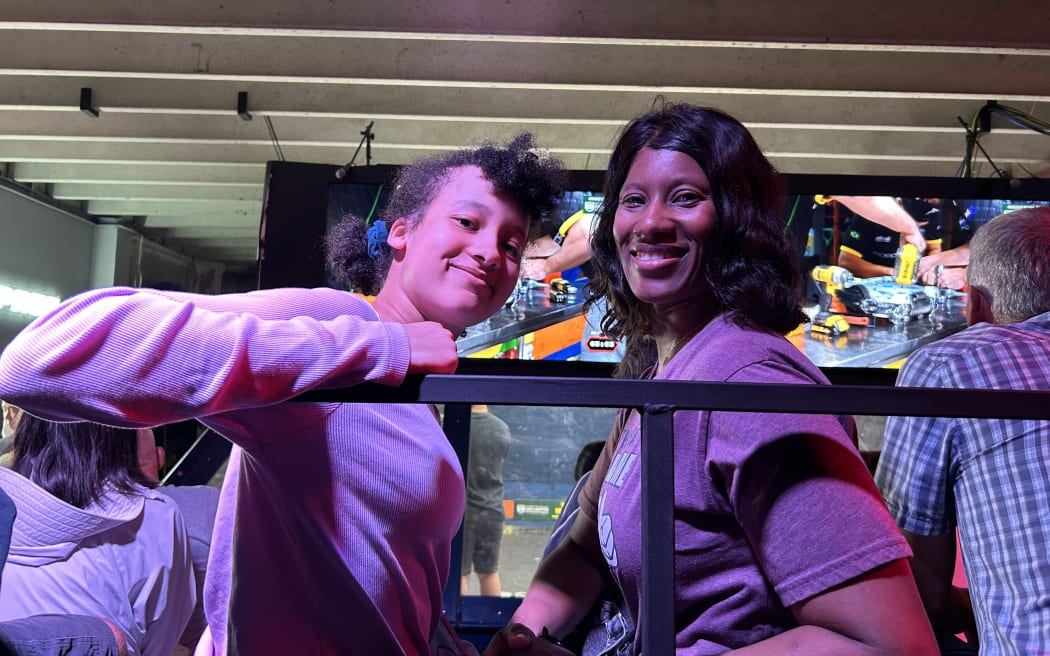 Photo of a 13-year-old girl and a woman, posing for a picture.