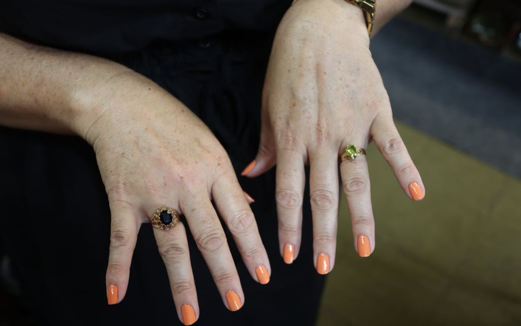 Close up photo of a pair of hands to showcase the two vintage rings.