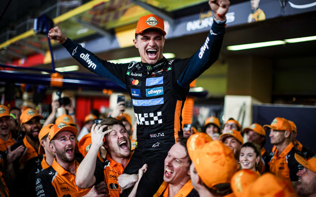 Lando Norris celebrates his F1 world championship with McLaren, Abu Dhabi, 2025.