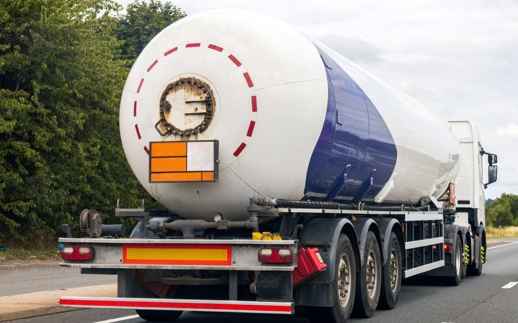A fuel tanker traveling along a motorway in the United Kingdom