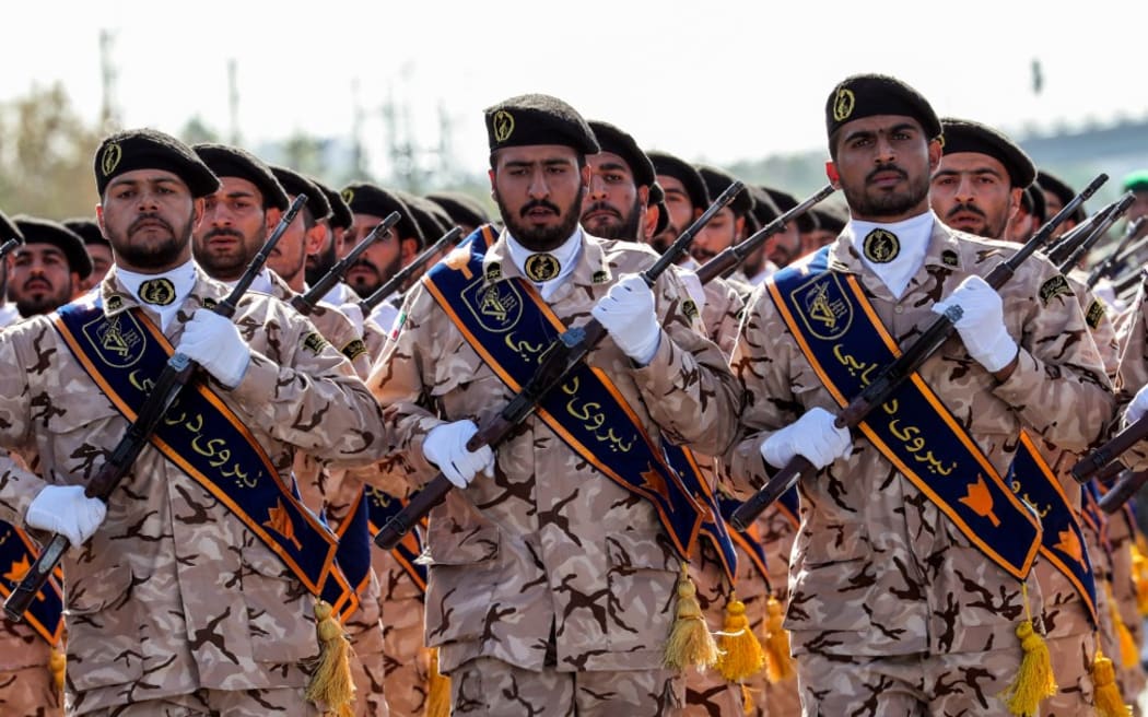 (FILES) In this file photo taken on September 22, 2018 members of Iran's Revolutionary Guards Corps (IRGC) march during the annual military parade