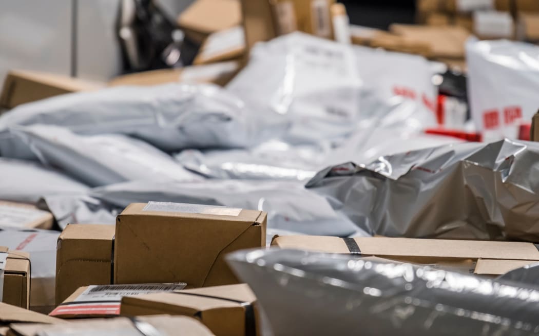 Huge amount of parcels and bags on conveyor belt.