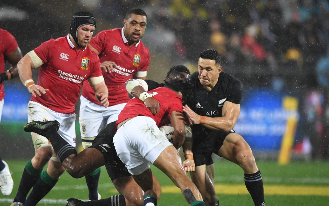 All Black Sonny Bill Williams (R) shoulder charges Lions winger Anthony Watson.