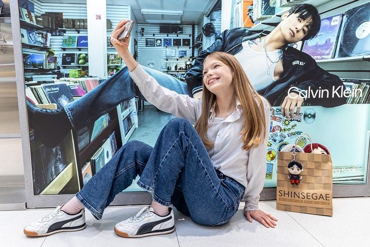 A girl takes a selfie at the K-WAVE Zone featuring K-pop merchandise at Shinsegae Duty Free Myeongdong in downtown Seoul, March 11. Yonhap