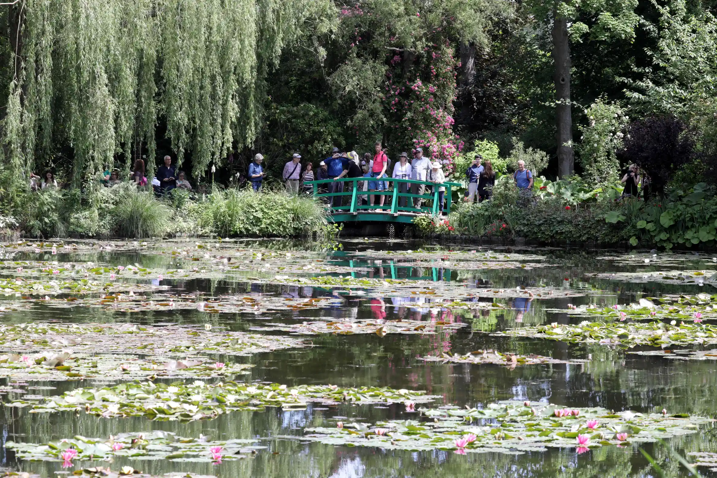 People on the bridge over the nympheas pond at the Claude Monet Foundation.