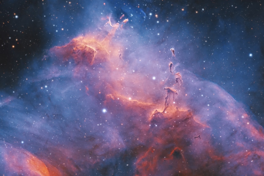 Swirling purple and blue nebula clouds with bright orange dabs scattered throughout.