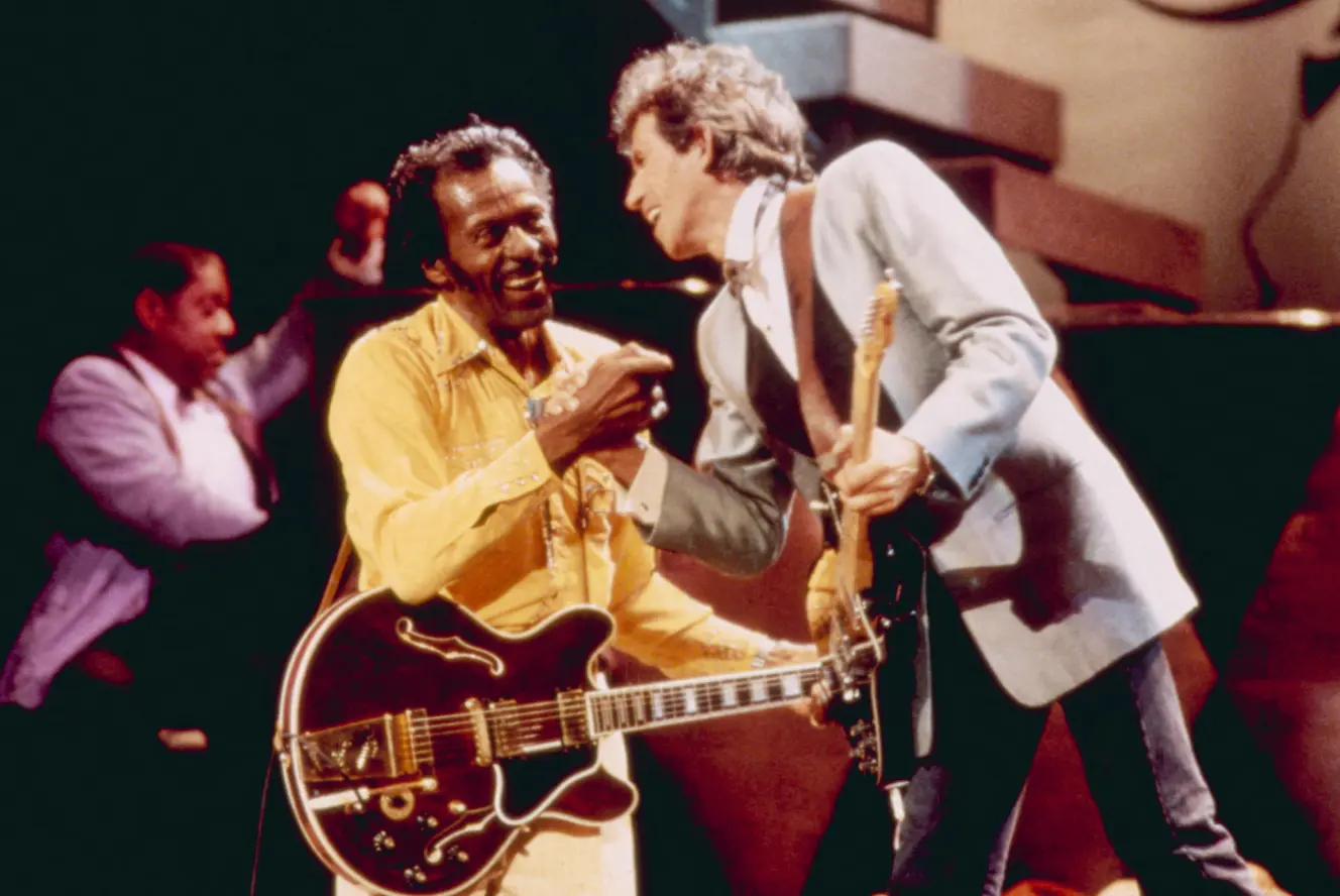 Chuck Berry and Keith Richards on stage with their guitars.