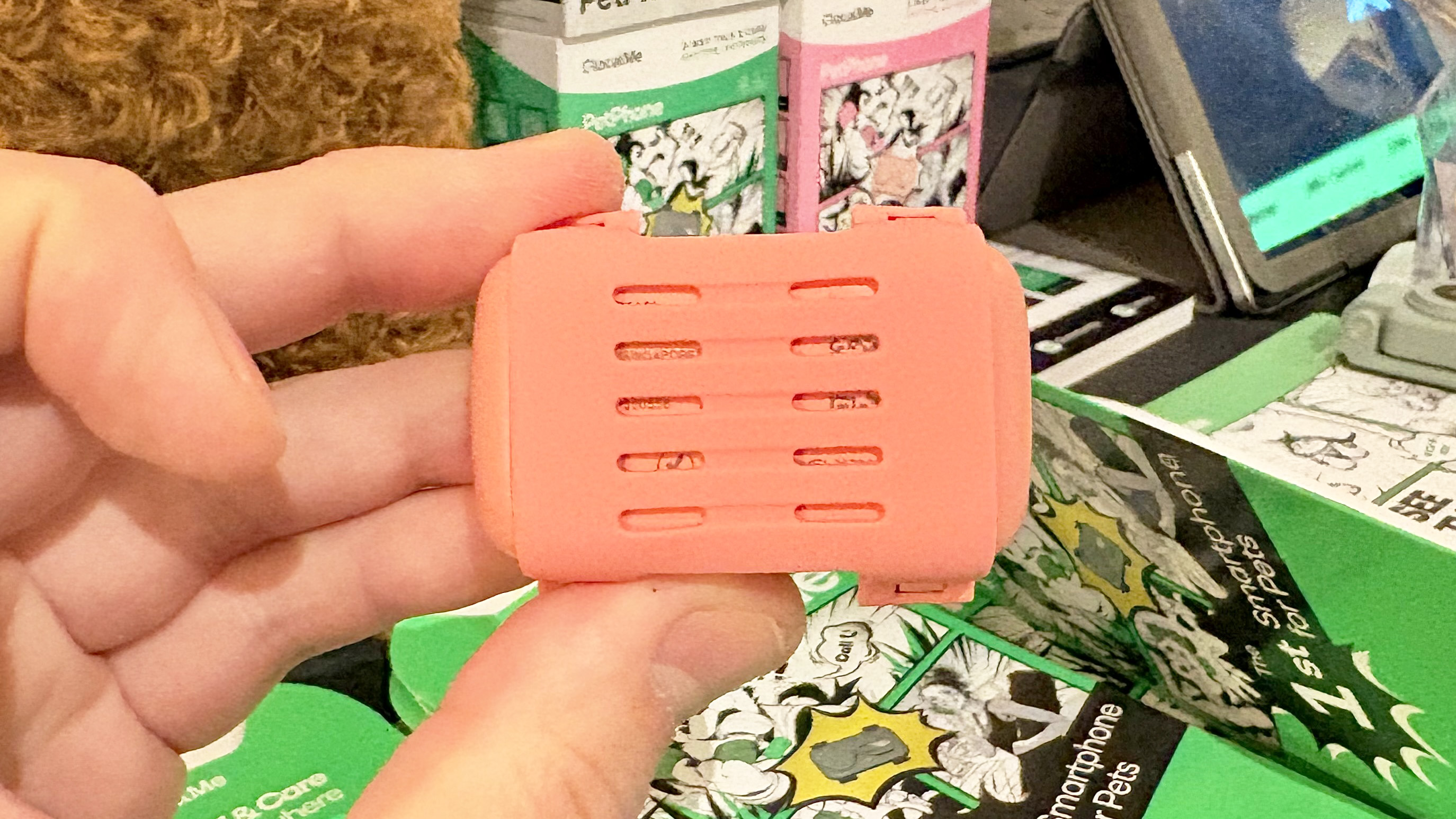 Close-up of the PetPhone, a wearable pet smartphone that attaches to a collar