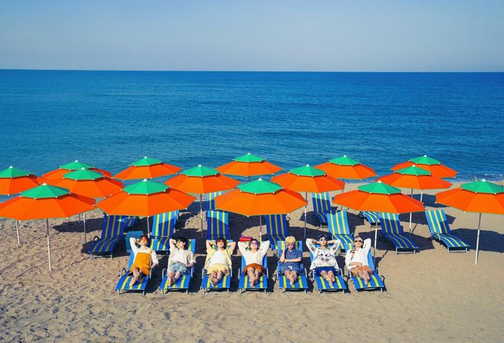 Members of K-pop boy band BTS pose in a promotional photo shot at Maengbang Beach in Samcheok, Gangwon Province. The coastal backdrop was used in imagery tied to the group’s global hit single “Butter.” Courtesy of BigHit Music