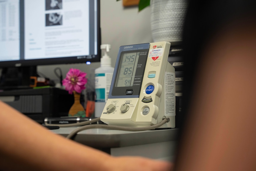 A doctor measuring a patient's blood pressure.