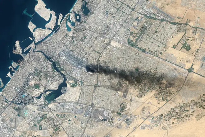 Satellite view of Dubai International Airport after a drone strike ignited a fuel tank fire