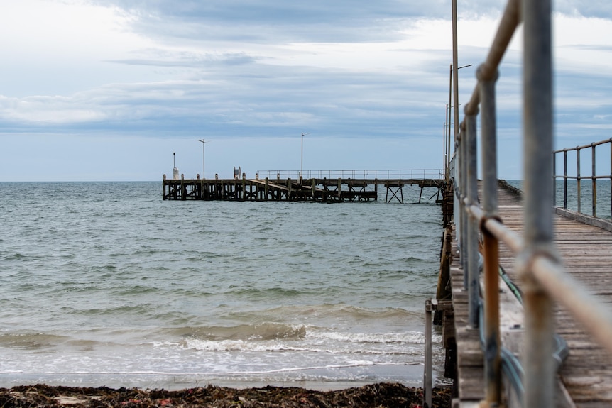 A jetty extending out over the water, made out of wood and metal