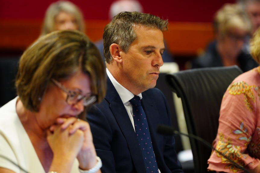 Ryan Park dressed in a dark suit and tie