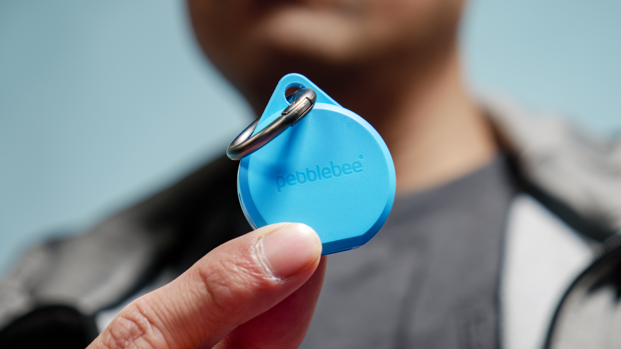 Pebblebee Clip 5 held in the hand.