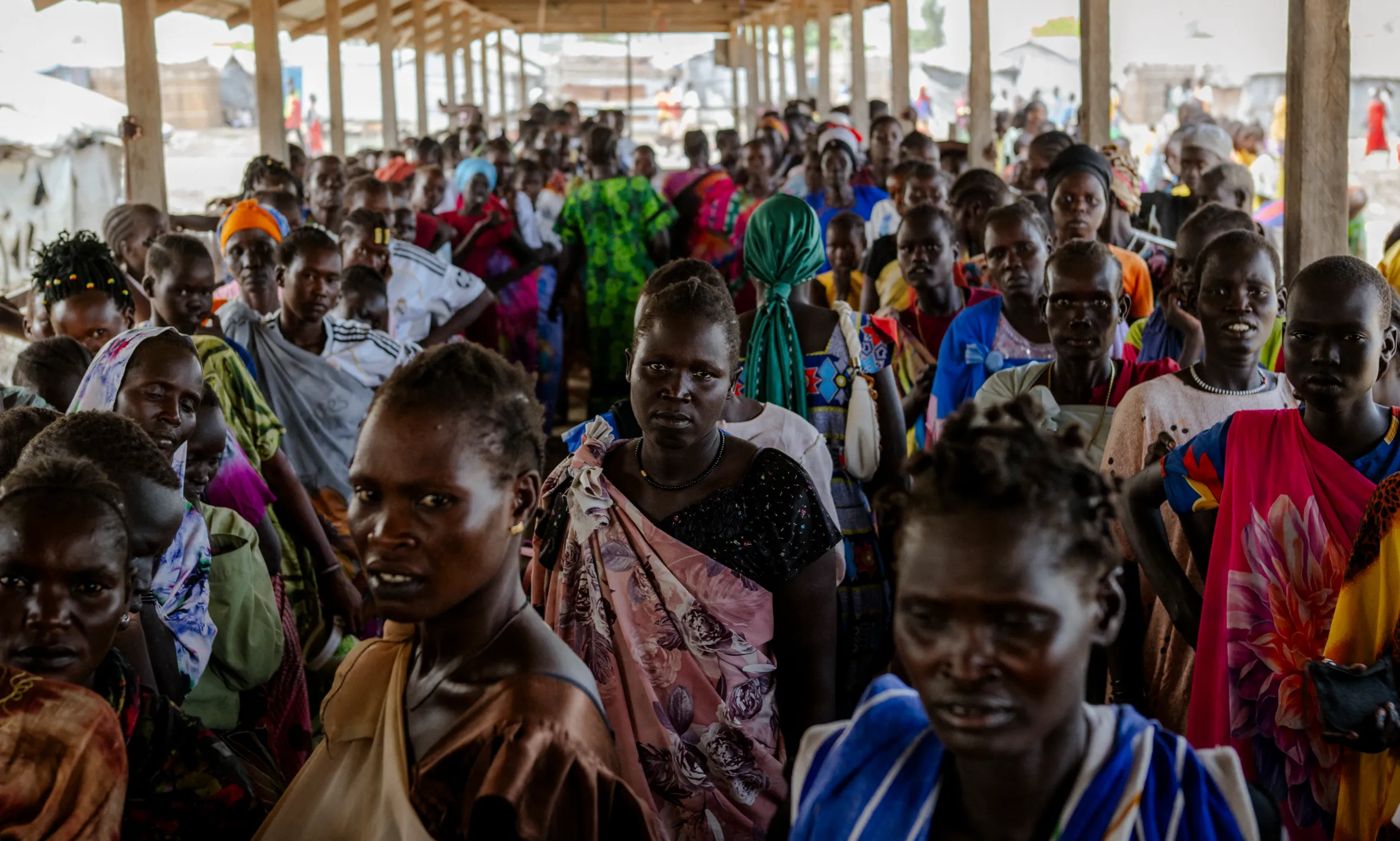 A large group of people waiting for food inside a distribution shed at the Bentiu internally displaced persons camp in Unity State, South Sudan.