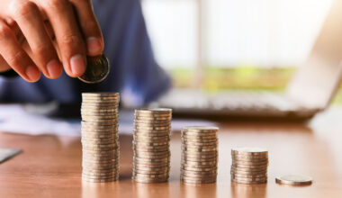 a person pilling euro coins