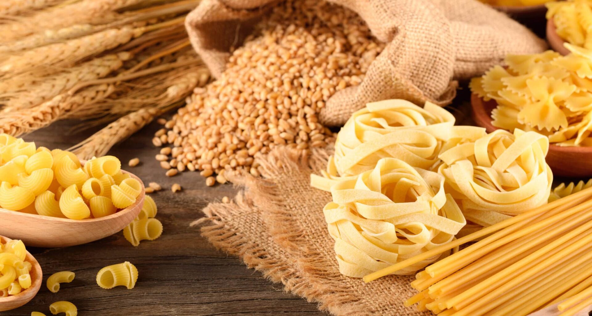 dried pasta and wheat on the wooden board