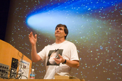 Alex Filippenko teaching in front of a picture of a comet
