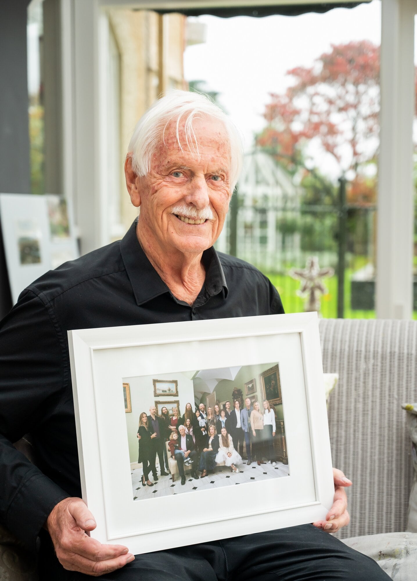 Wayne Wright snr posing with an extended family photo in 2025. Photo / Brydie Thompson