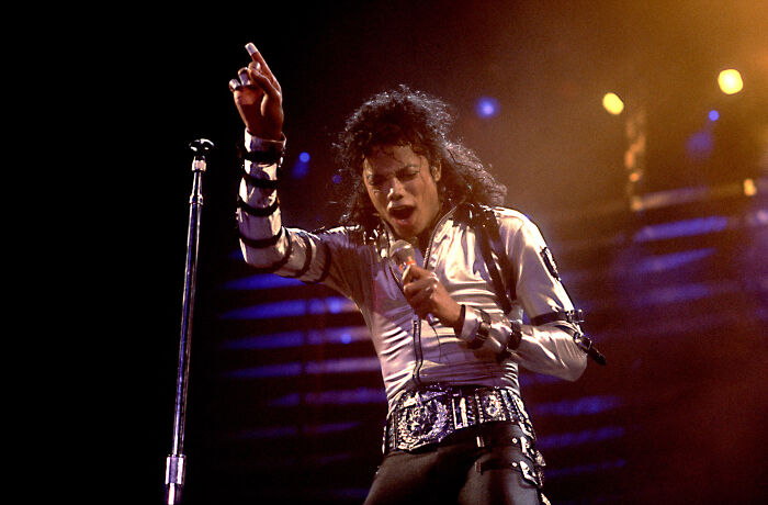 Performer mimicking Michael Jackson in a stage outfit, highlighting the Michael movie cast in the new biopic production.