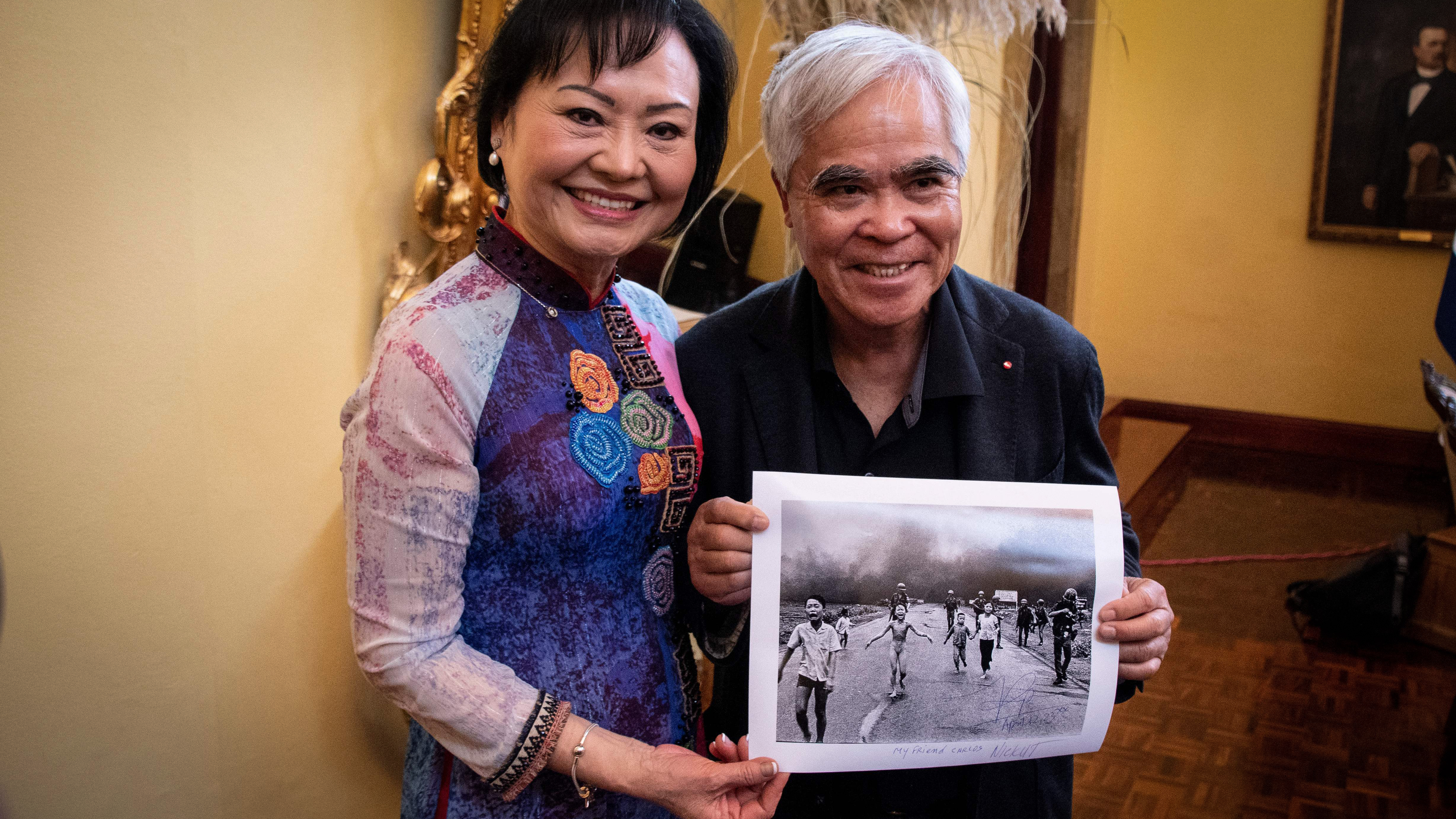 Vietnam War survivor Kim Phuc Phan Thi (L), also known as the "Napalm Girl," poses with photojournalist Nick Ut holding his 1972 Pulitzer Prize and World Press Photo award-winning photograph during the presentation of the Spanish edition of her book at the Ministry of Foreign Affairs and Worship in San Jos&eacute; on April 12, 2023