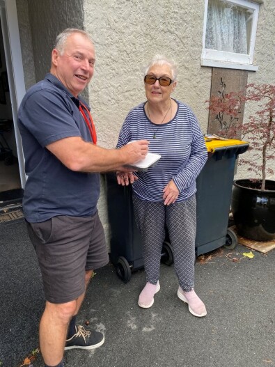 ElectroNet Group Network Lines Manager Terry Hughes delivering a meal to Lorraine Menzies in Greymouth. 