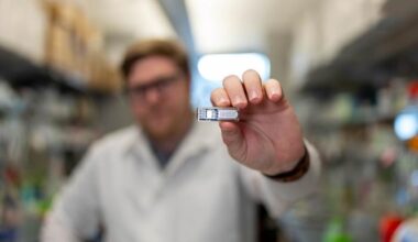 An image showing a student holding up the implantable device