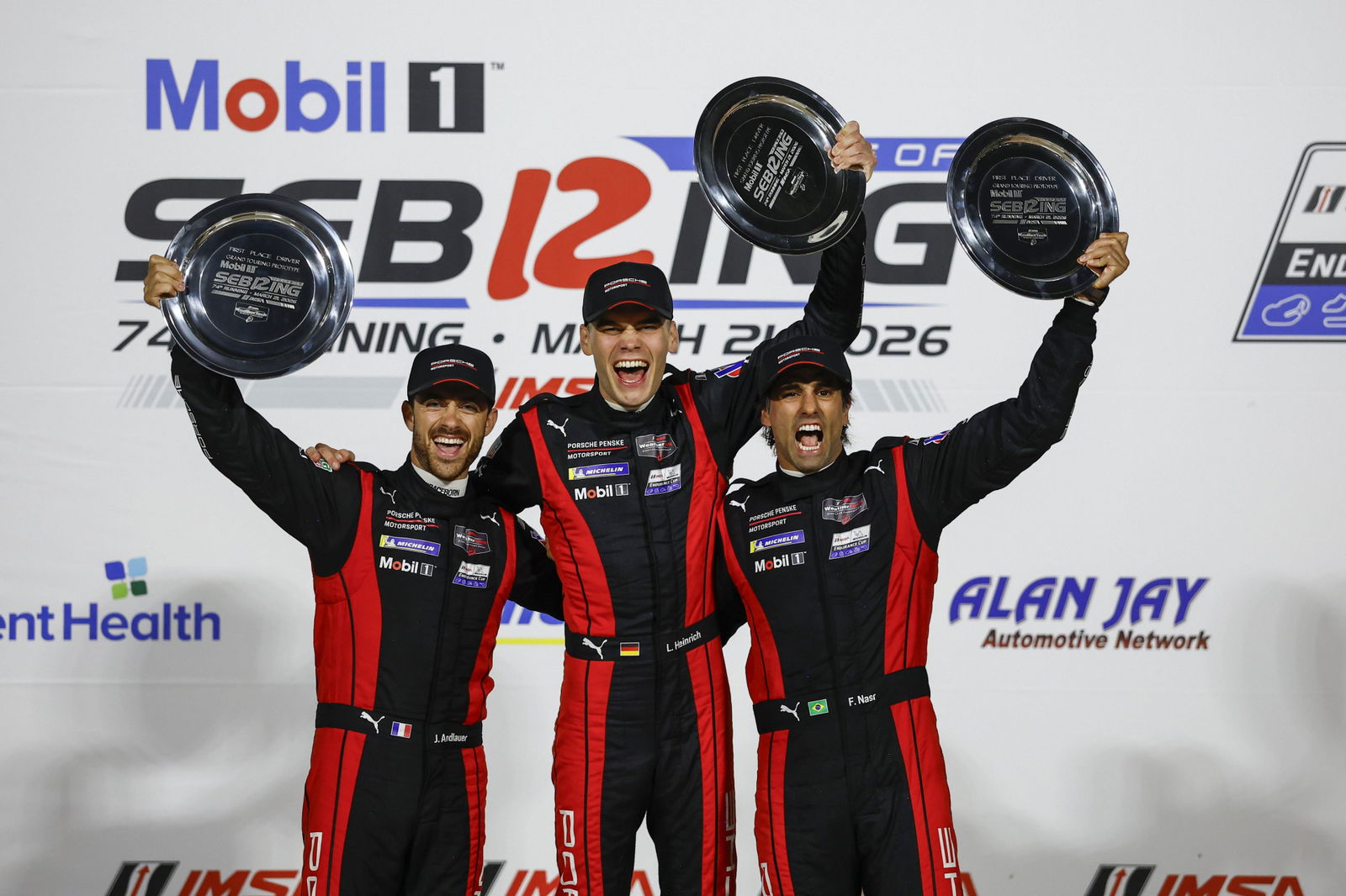 Felipe Nasr, Laurin Heinrich, and Julien Andlauer celebrate winning the Sebring 12 Hours.